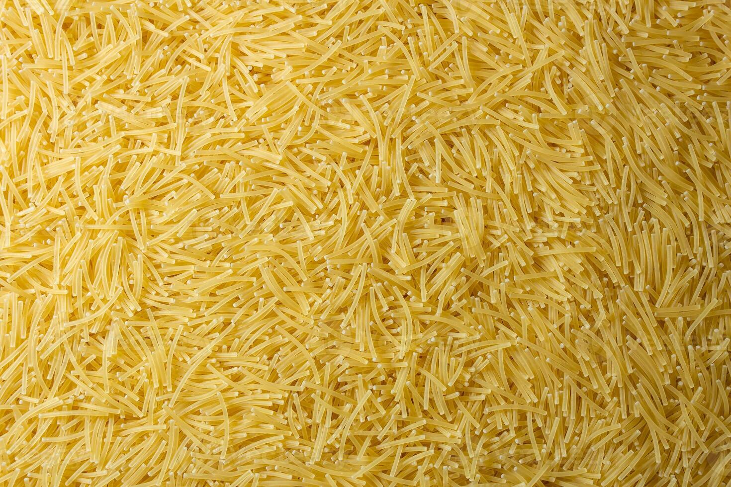 Uncooked Filini Pasta. A Culinary Canvas of Noodles, Creating a Lively and Textured Background for Gourmet Cooking. Dry Pasta. Raw Macaroni - Top View, Flat Lay photo
