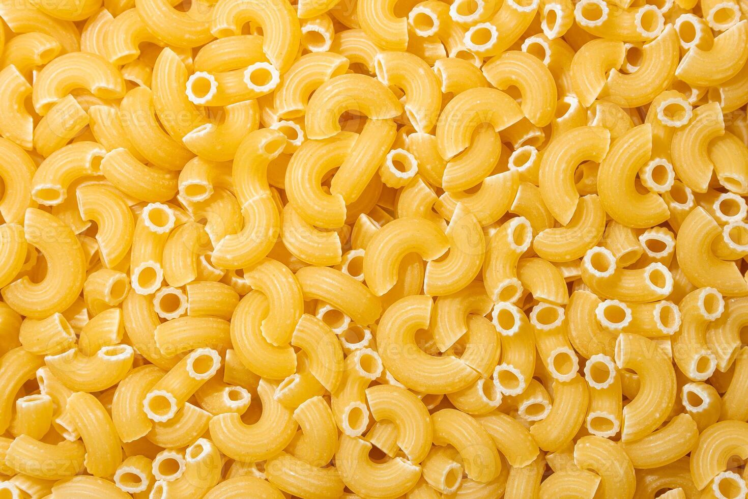 Uncooked Chifferi Rigati Pasta. A Culinary Canvas of Chifferi Rigati, Creating a Lively and Textured Background for Gourmet Cooking. Dry Pasta. Raw Macaroni - Top View, Flat Lay photo