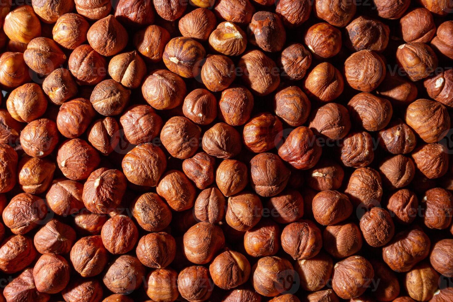 Scattered Peeled Hazelnut - Top View. Background from Hazelnuts. Natural High-Calorie Snacks photo