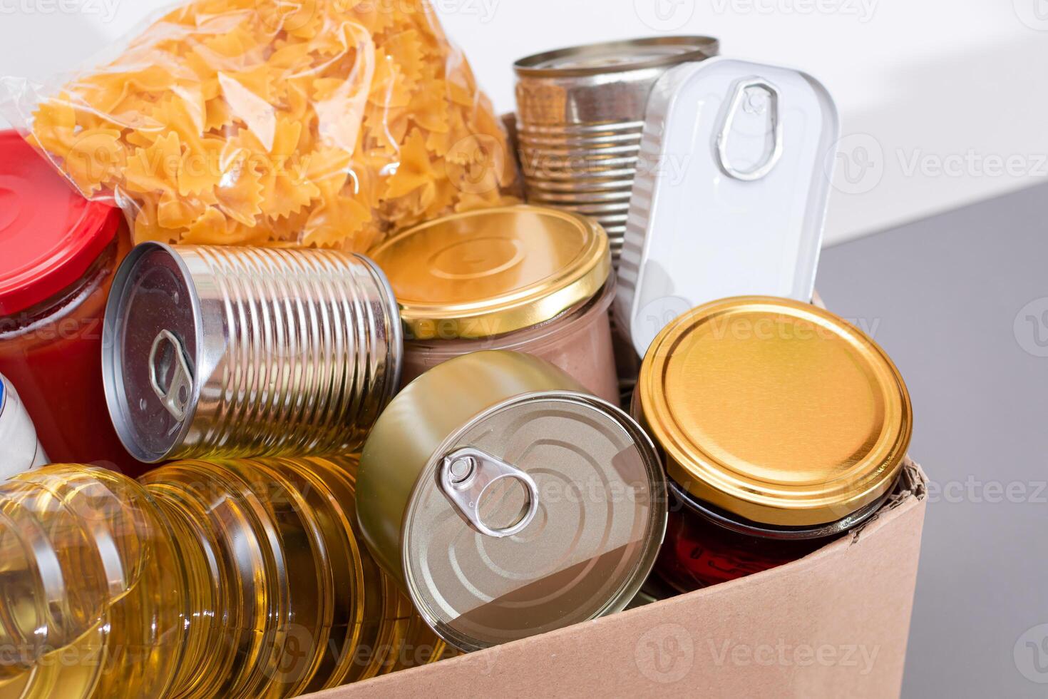 Donation Box of Free Food. Carton Box with Canned Food, Cereals and Grocery. Meal Reserves. Emergency Food Storage in Case of Crisis. Free Social Help, Blessings and Care. Strategic Food Supplies photo