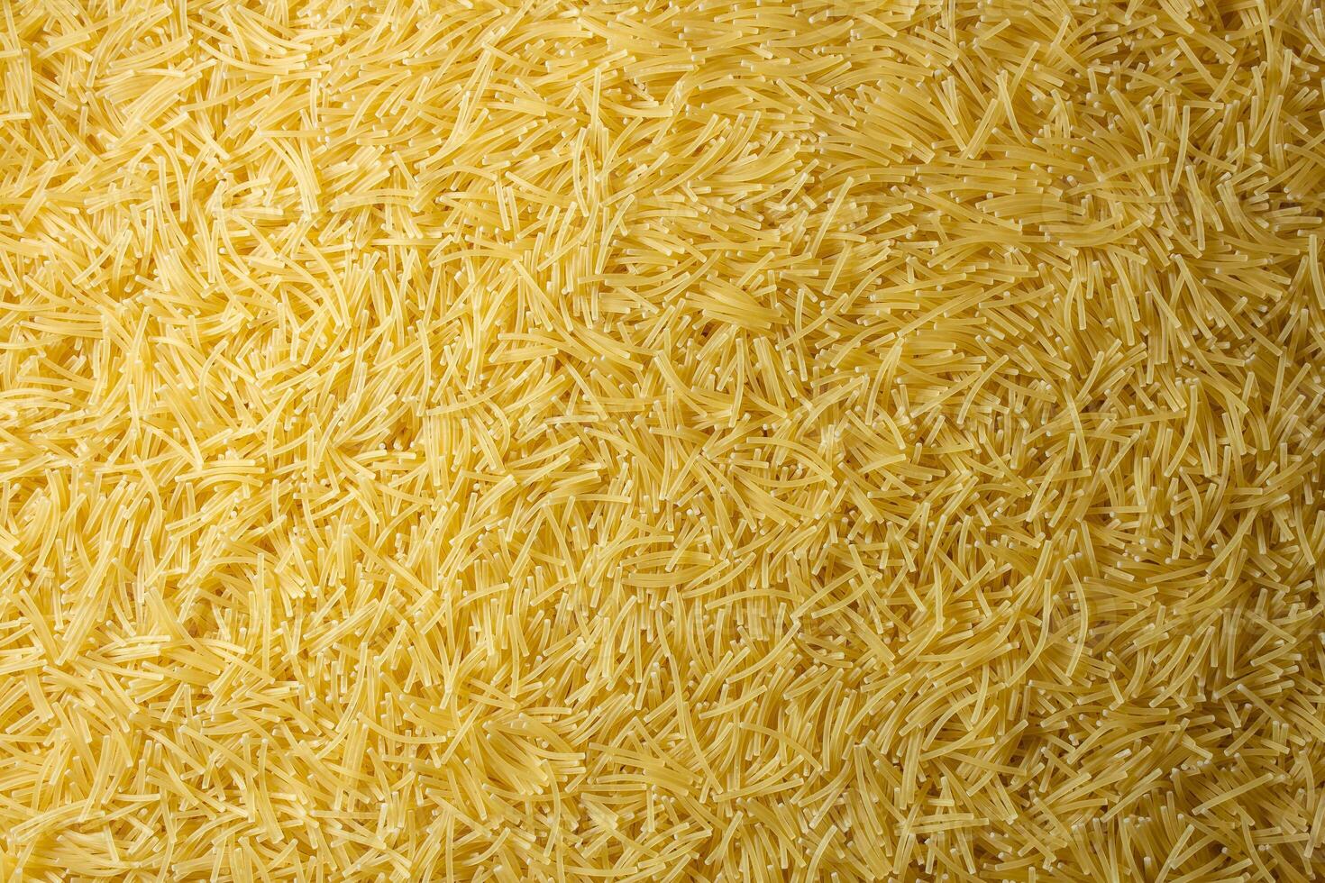 Uncooked Filini Pasta. A Culinary Canvas of Noodles, Creating a Lively and Textured Background for Gourmet Cooking. Dry Pasta. Raw Macaroni - Top View, Flat Lay photo