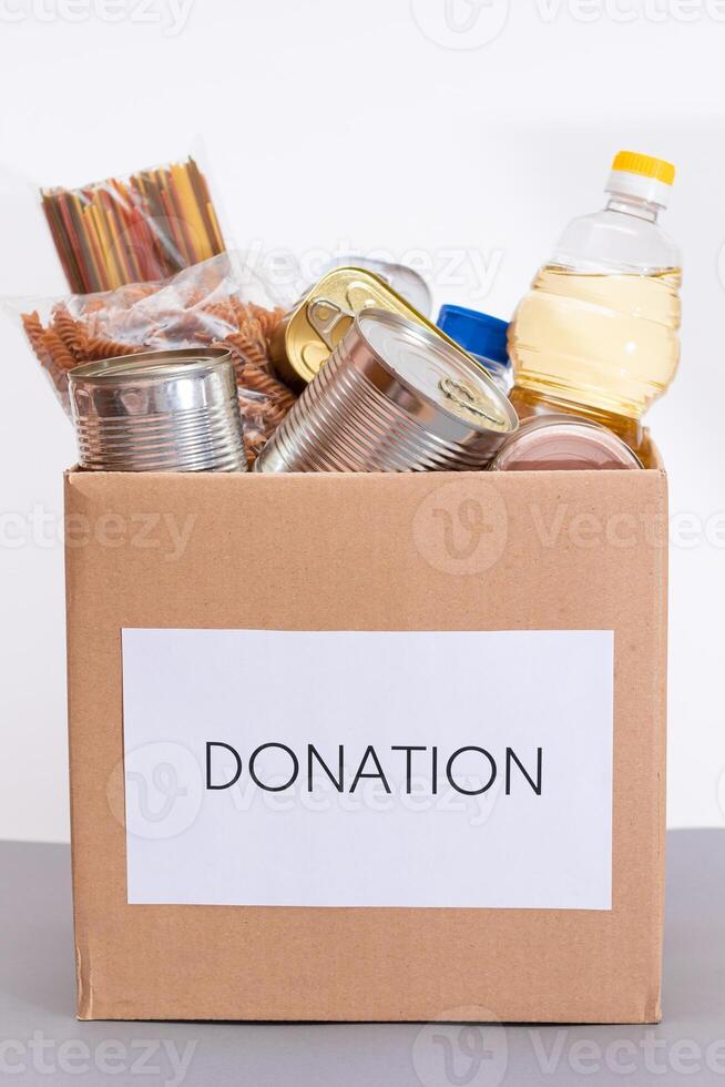 Donation Box of Free Food. Carton Box with Canned Food, Cereals and Grocery. Meal Reserves. Emergency Food Storage in Case of Crisis. Free Social Help, Blessings and Care. Strategic Food Supplies photo