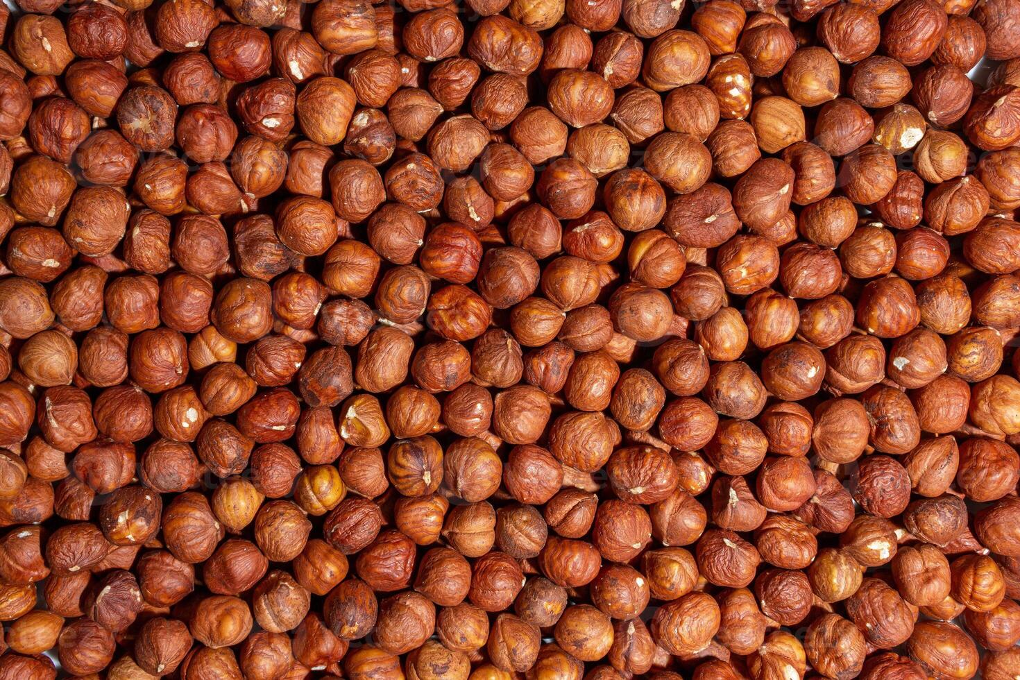 Scattered Peeled Hazelnut - Top View. Background from Hazelnuts. Natural High-Calorie Snacks photo