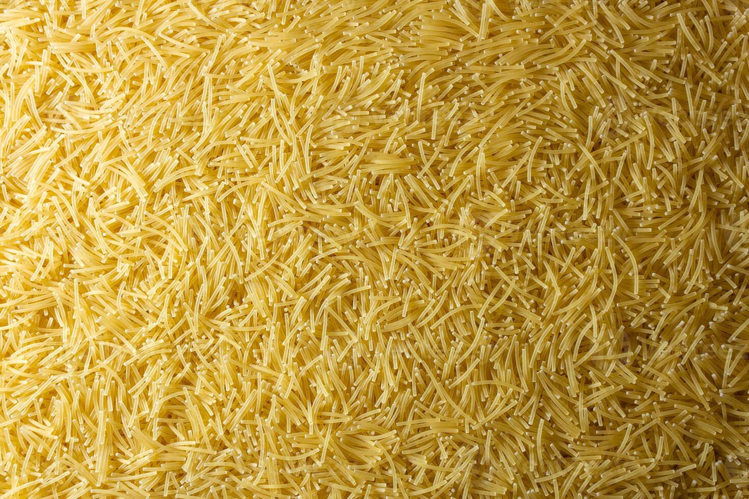 Uncooked Filini Pasta. A Culinary Canvas of Noodles, Creating a Lively and Textured Background for Gourmet Cooking. Dry Pasta. Raw Macaroni - Top View, Flat Lay photo