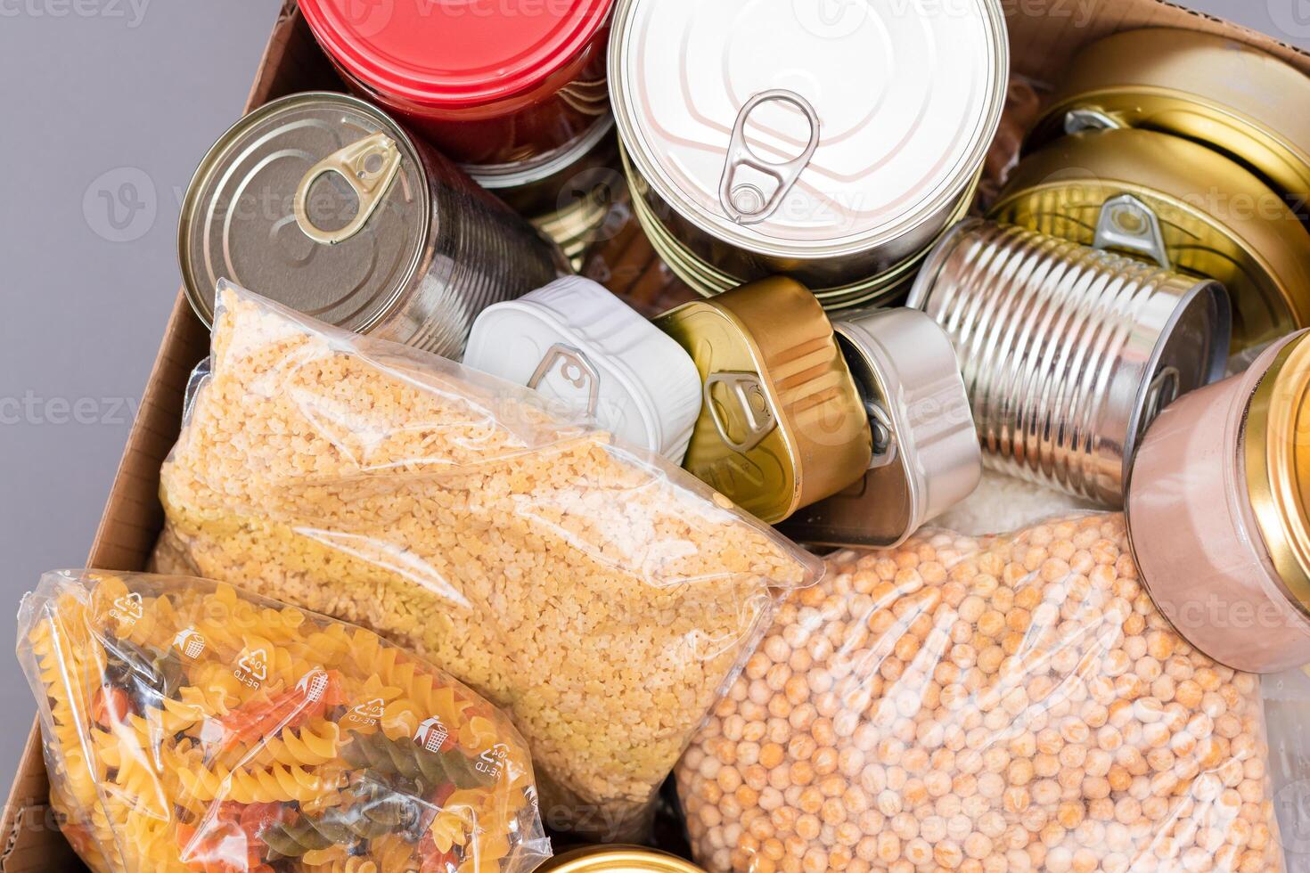 Donation Box of Free Food. Carton Box with Canned Food, Cereals and Grocery. Meal Reserves. Emergency Food Storage in Case of Crisis. Free Social Help, Blessings and Care. Strategic Food Supplies photo