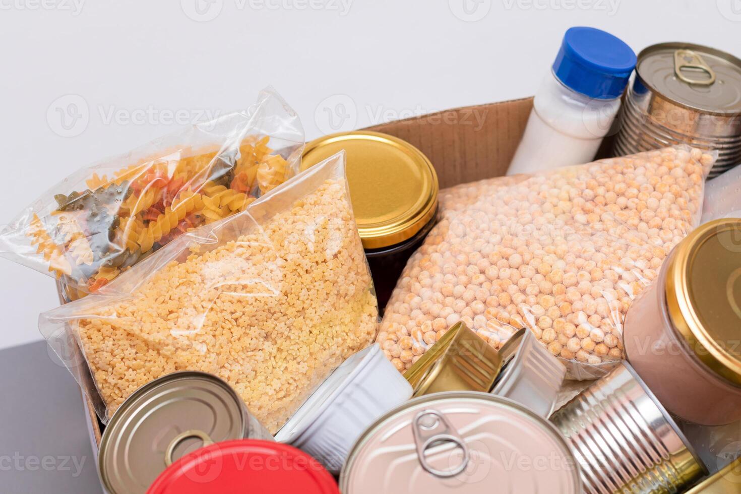 Donation Box of Free Food. Carton Box with Canned Food, Cereals and Grocery. Meal Reserves. Emergency Food Storage in Case of Crisis. Free Social Help, Blessings and Care. Strategic Food Supplies photo