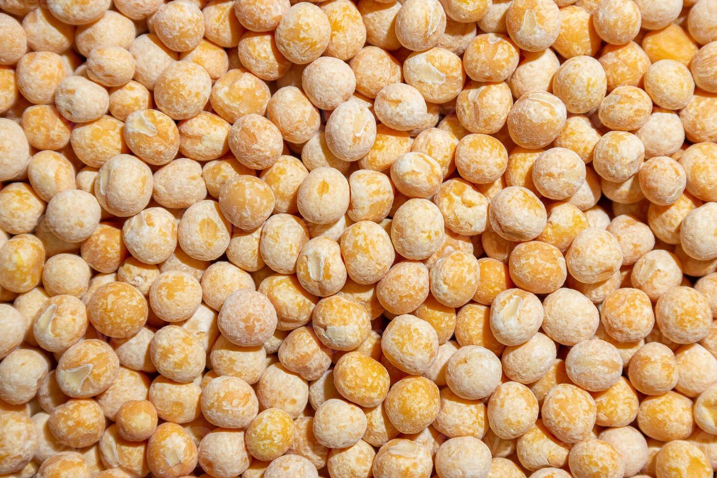 Uncooked Yellow Polished Peas Background. A Culinary Canvas of Dry Yellow Peas, Creating a Lively and Textured Background for Gourmet Cooking. Scattered Raw Polished Peas. Healthy Eating Ingredients photo