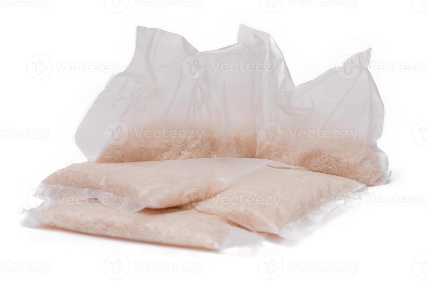A Plastic Bags of White Long Grain Rice - Isolated on White Background. Small Transparent Packages with Dry Rice - Isolation photo
