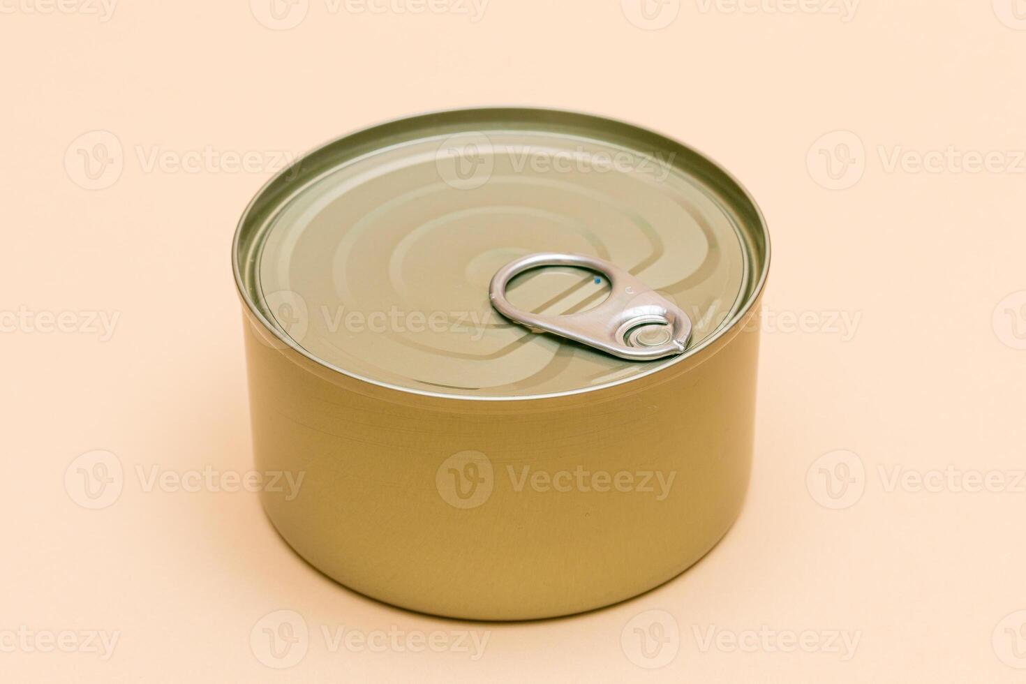 Unopened Tin Can with Blank Edge on Beige Background. Canned Food. Aluminum Can for Safe and Long Term Storage of Food. Steel Sealed Food Storage Container photo