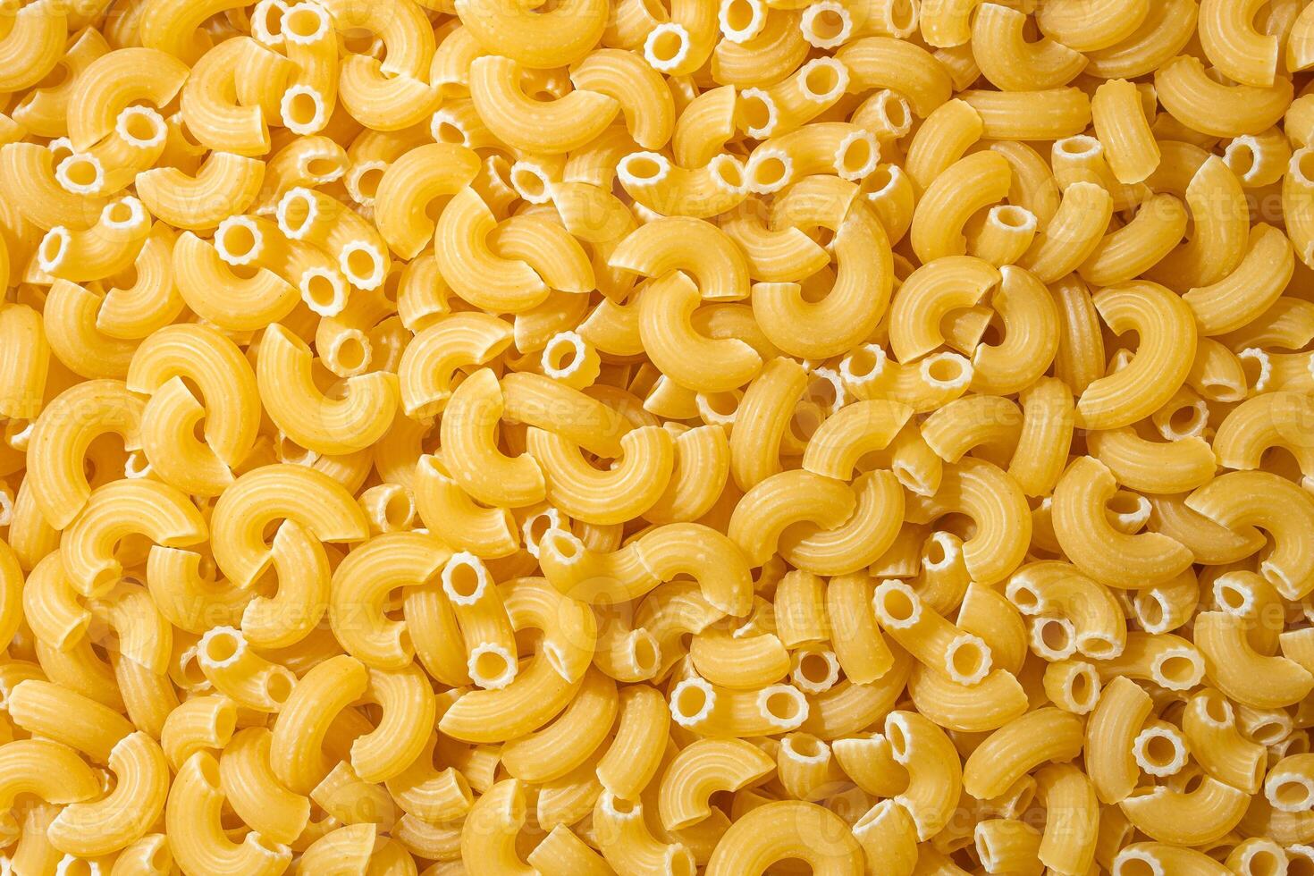 Uncooked Chifferi Rigati Pasta. A Culinary Canvas of Chifferi Rigati, Creating a Lively and Textured Background for Gourmet Cooking. Dry Pasta. Raw Macaroni - Top View, Flat Lay photo