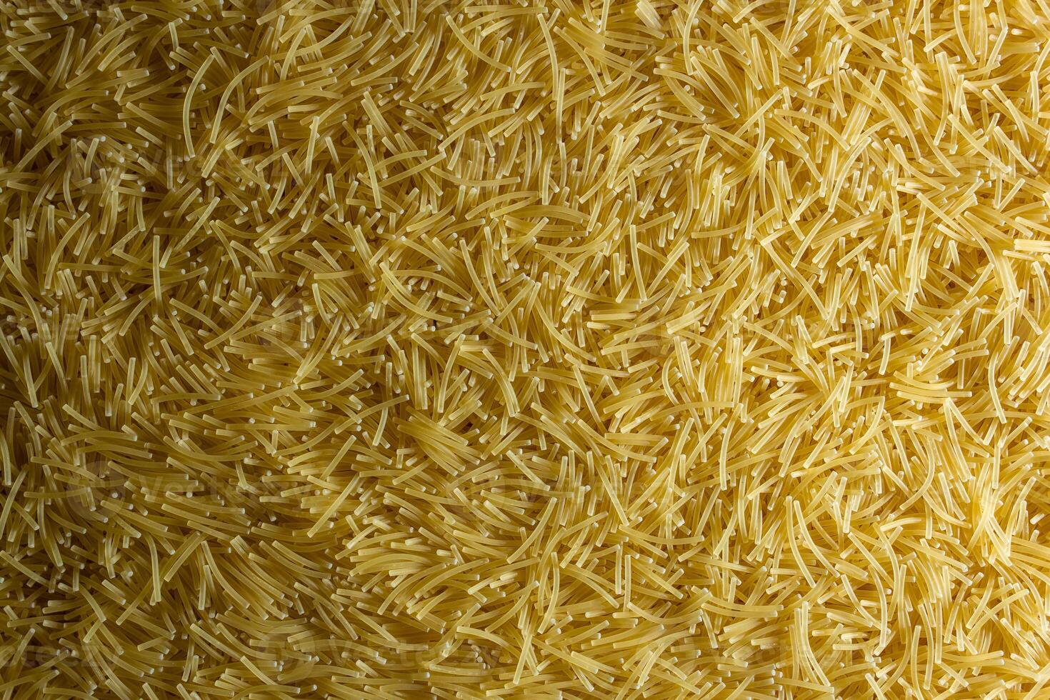 Uncooked Filini Pasta. A Culinary Canvas of Noodles, Creating a Lively and Textured Background for Gourmet Cooking. Dry Pasta. Raw Macaroni - Top View, Flat Lay photo