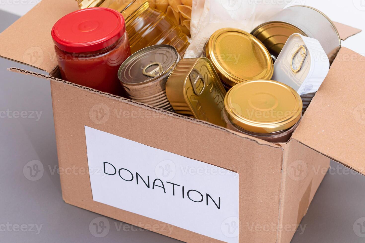Donation Box of Free Food. Carton Box with Canned Food, Cereals and Grocery. Meal Reserves. Emergency Food Storage in Case of Crisis. Free Social Help, Blessings and Care. Strategic Food Supplies photo