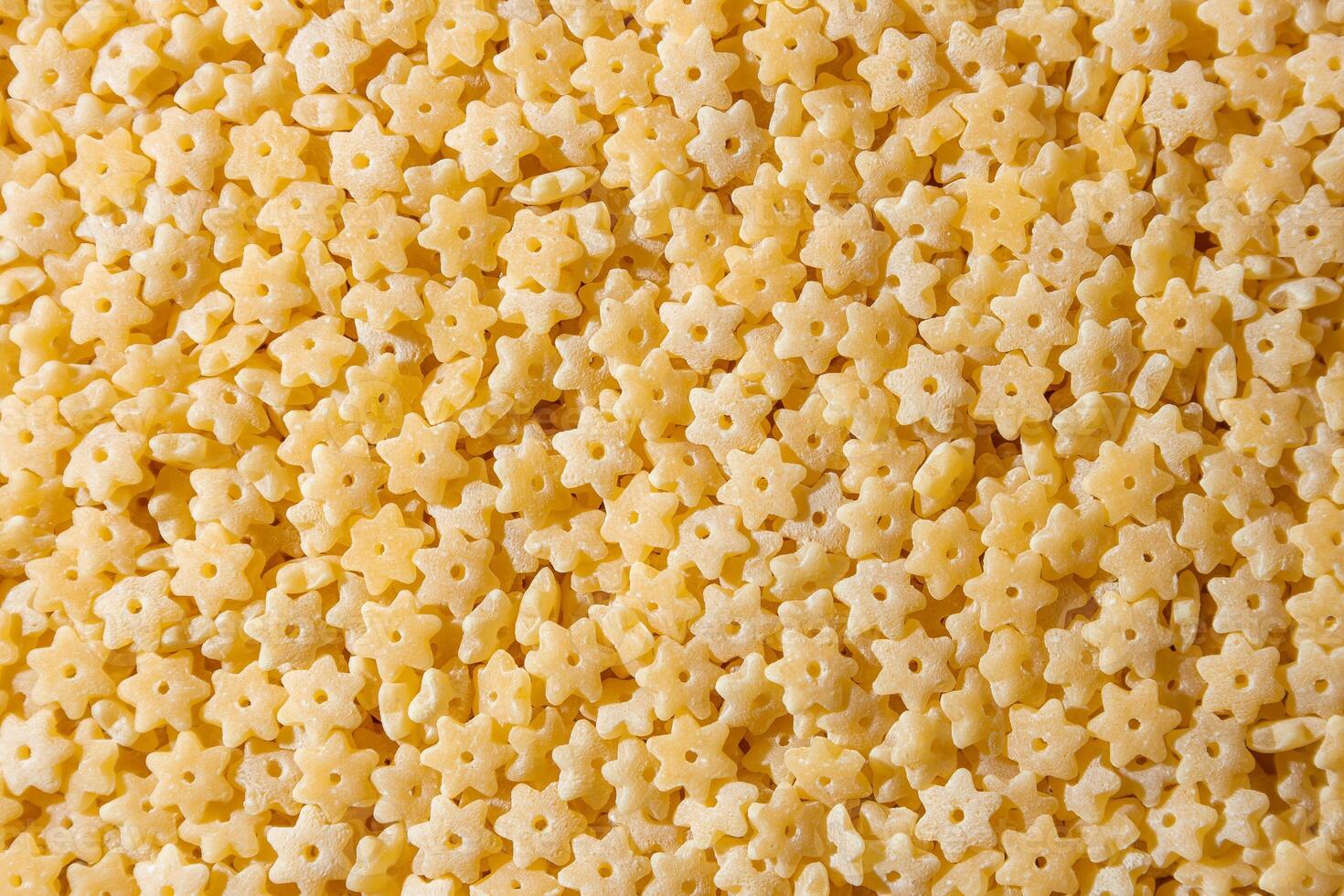 Uncooked Stelline Pasta. A Culinary Canvas of Stelline Macaroni, Creating a Lively and Textured Background for Gourmet Cooking. Dry Pasta. Raw Macaroni - Top View, Flat Lay photo