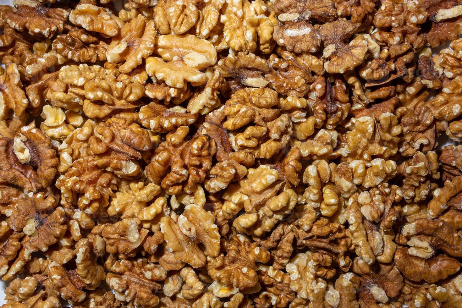 Scattered Shelled Walnuts. Background from Walnut. Natural High-Calorie Snacks photo