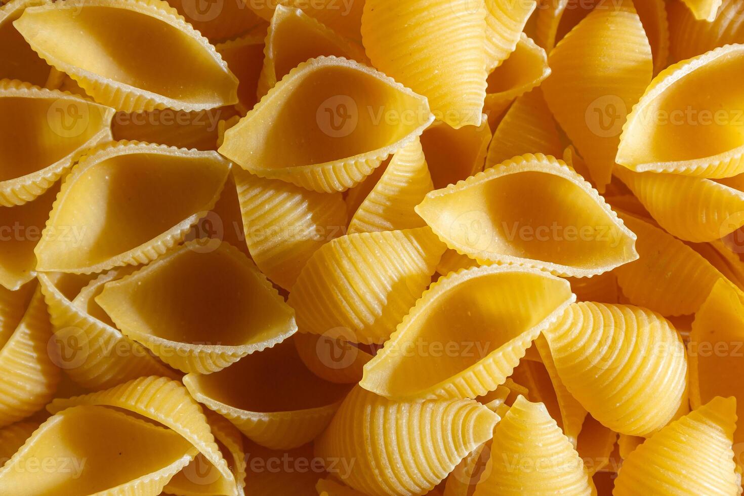 Uncooked Conchiglie Pasta. A Culinary Canvas of Conchiglie Macaroni, Creating a Lively and Textured Background for Gourmet Cooking. Dry Pasta. Raw Macaroni - Top View, Flat Lay photo