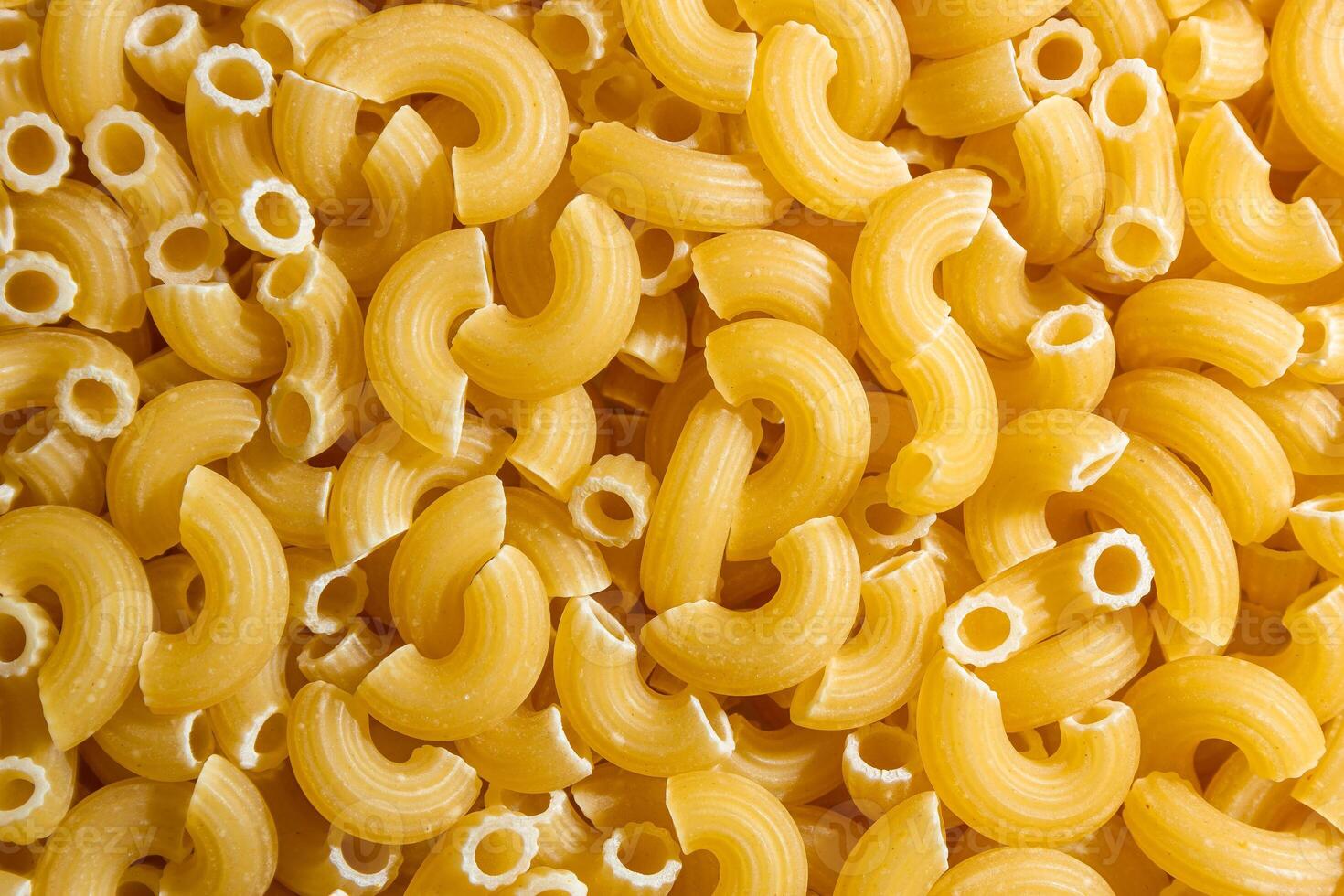 Uncooked Chifferi Rigati Pasta. A Culinary Canvas of Chifferi Rigati, Creating a Lively and Textured Background for Gourmet Cooking. Dry Pasta. Raw Macaroni - Top View, Flat Lay photo