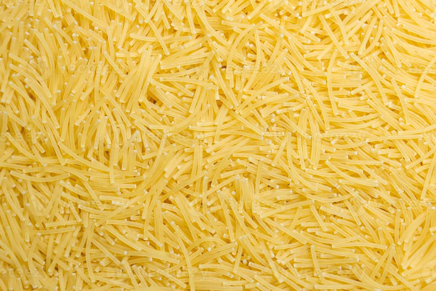 Uncooked Filini Pasta. A Culinary Canvas of Noodles, Creating a Lively and Textured Background for Gourmet Cooking. Dry Pasta. Raw Macaroni - Top View, Flat Lay photo