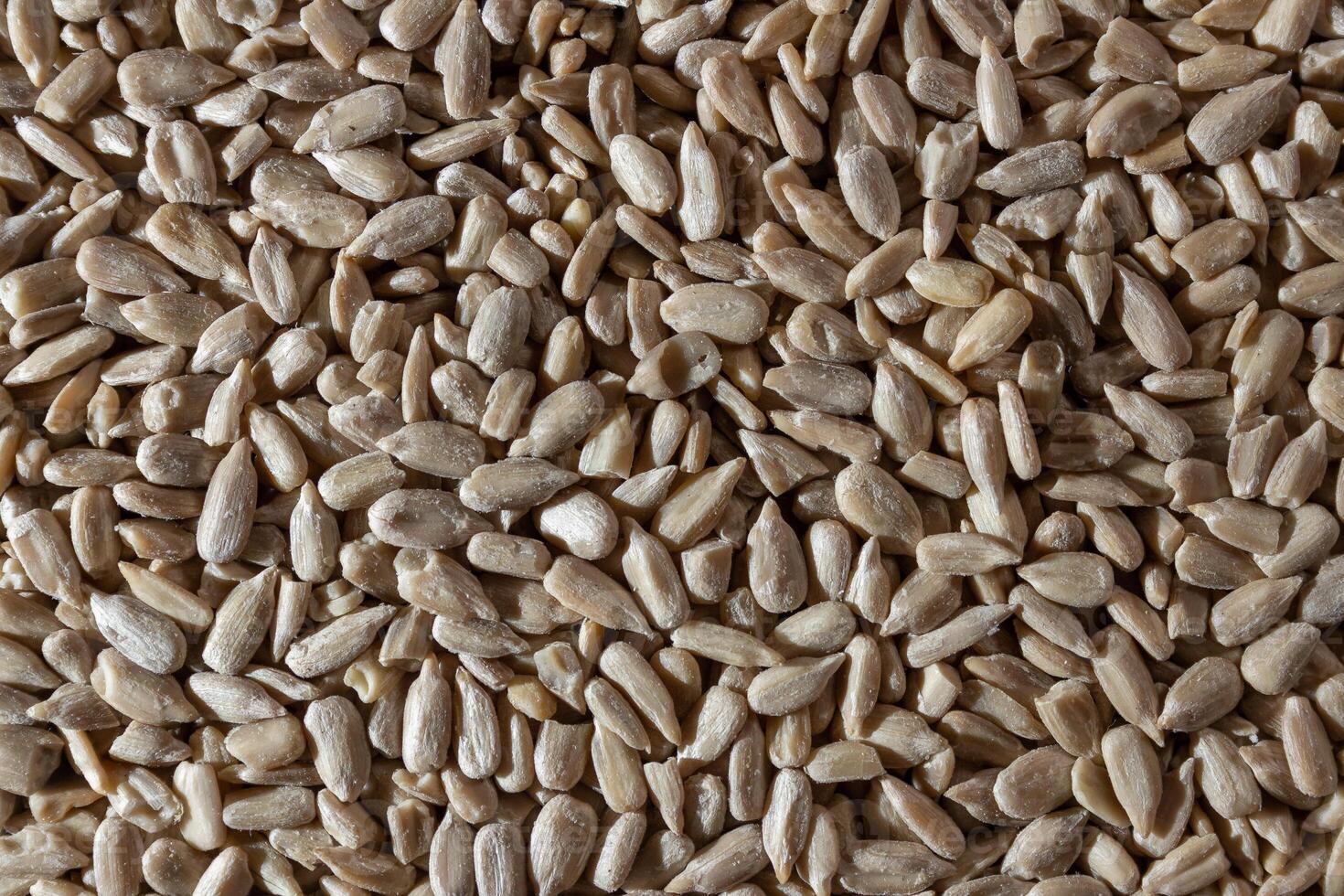 Peeled Sunflower Seeds Background. A Culinary Canvas of Shell-free Sunflower Seeds, Creating a Lively and Textured Background for Gourmet Cooking - Top View, Flat Lay photo