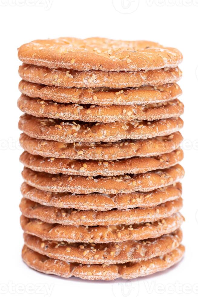 A Stack of Round Salt Crackers with Sesame Isolated on White Background. Dry Snacks - Isolation photo