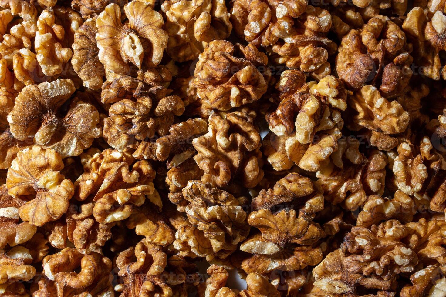 Scattered Shelled Walnuts. Background from Walnut. Natural High-Calorie Snacks photo
