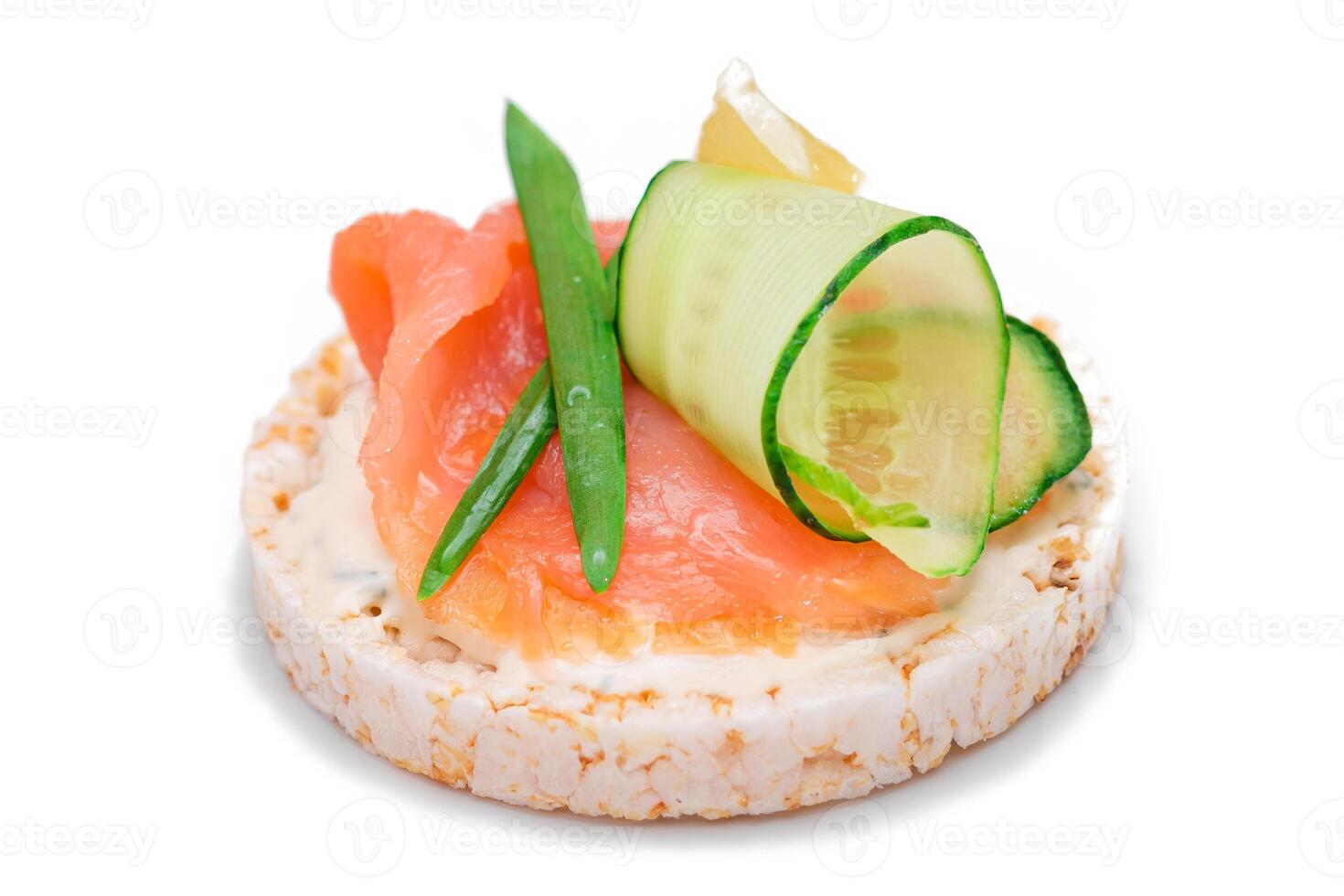 Rice Cake Sandwich with Fresh Salmon, Lemon and Greens - Isolated on White Background. Diet Food. Quick and Healthy Sandwiches. Crispbread with Fresh Fillings. Healthy Dietary Snack photo