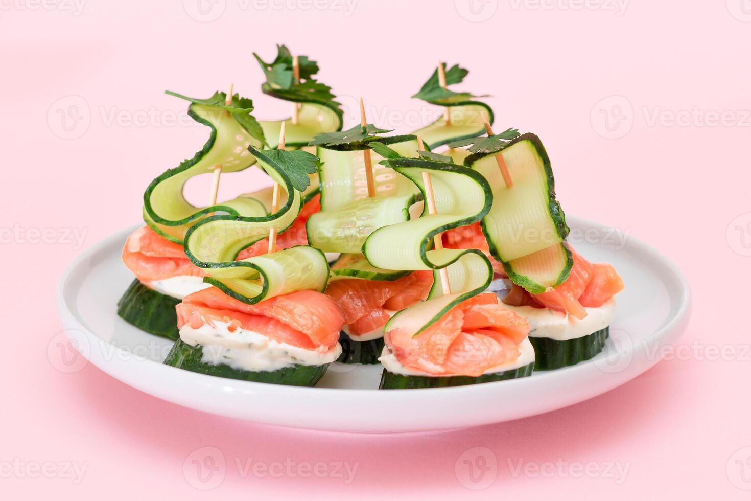 Canapes without Bread with Fresh Salmon, Cucumber and Cream Cheese on White Plate. Easy Breakfast. Diet Food. Quick and Healthy Sandwiches. Healthy Snacks with Tasty Fillings photo