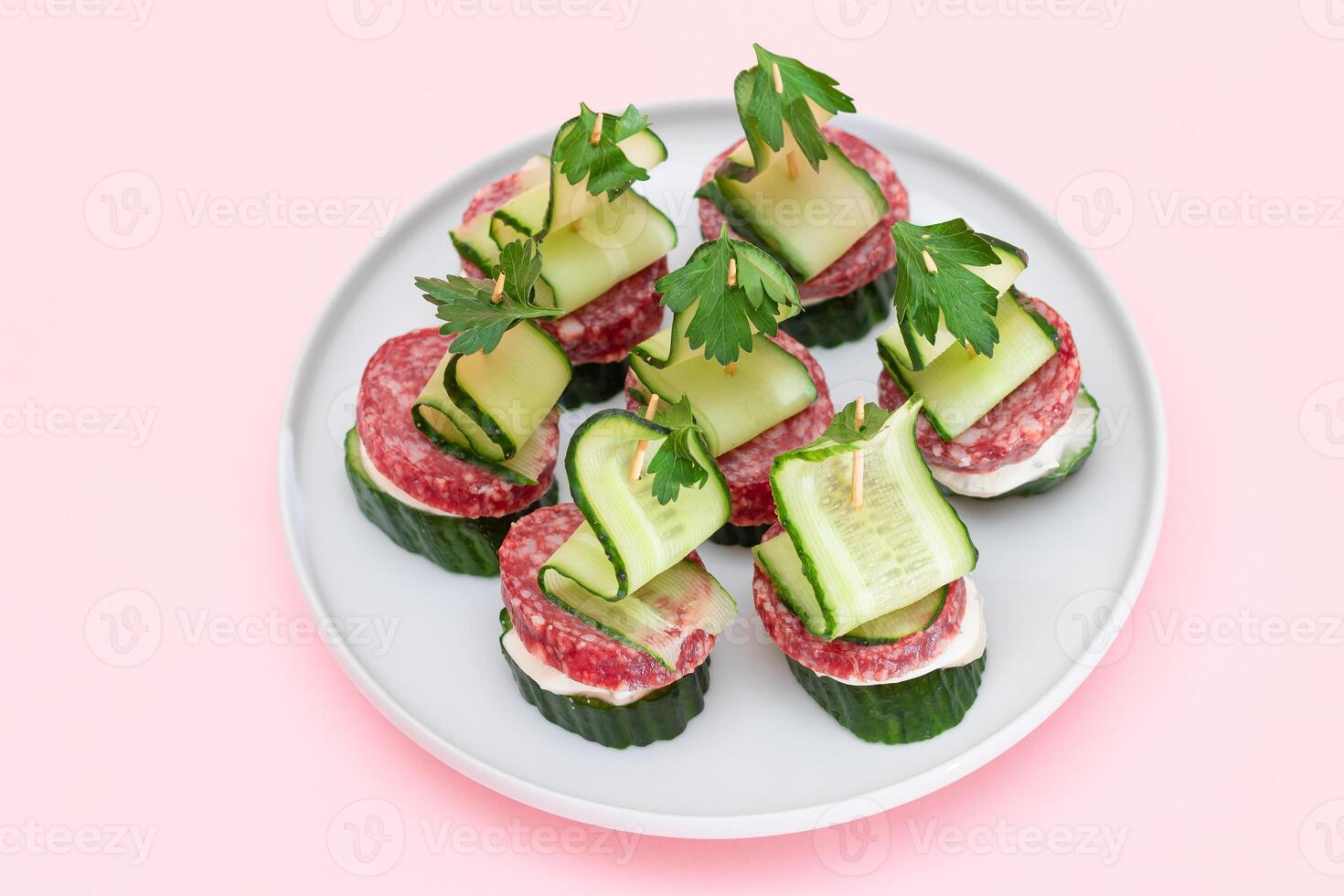 Canapes without Bread with Salami, Cucumber, Greens and Cream Cheese on White Plate. Easy Breakfast. Diet Food. Quick and Healthy Sandwiches. Healthy Snacks with Tasty Fillings photo
