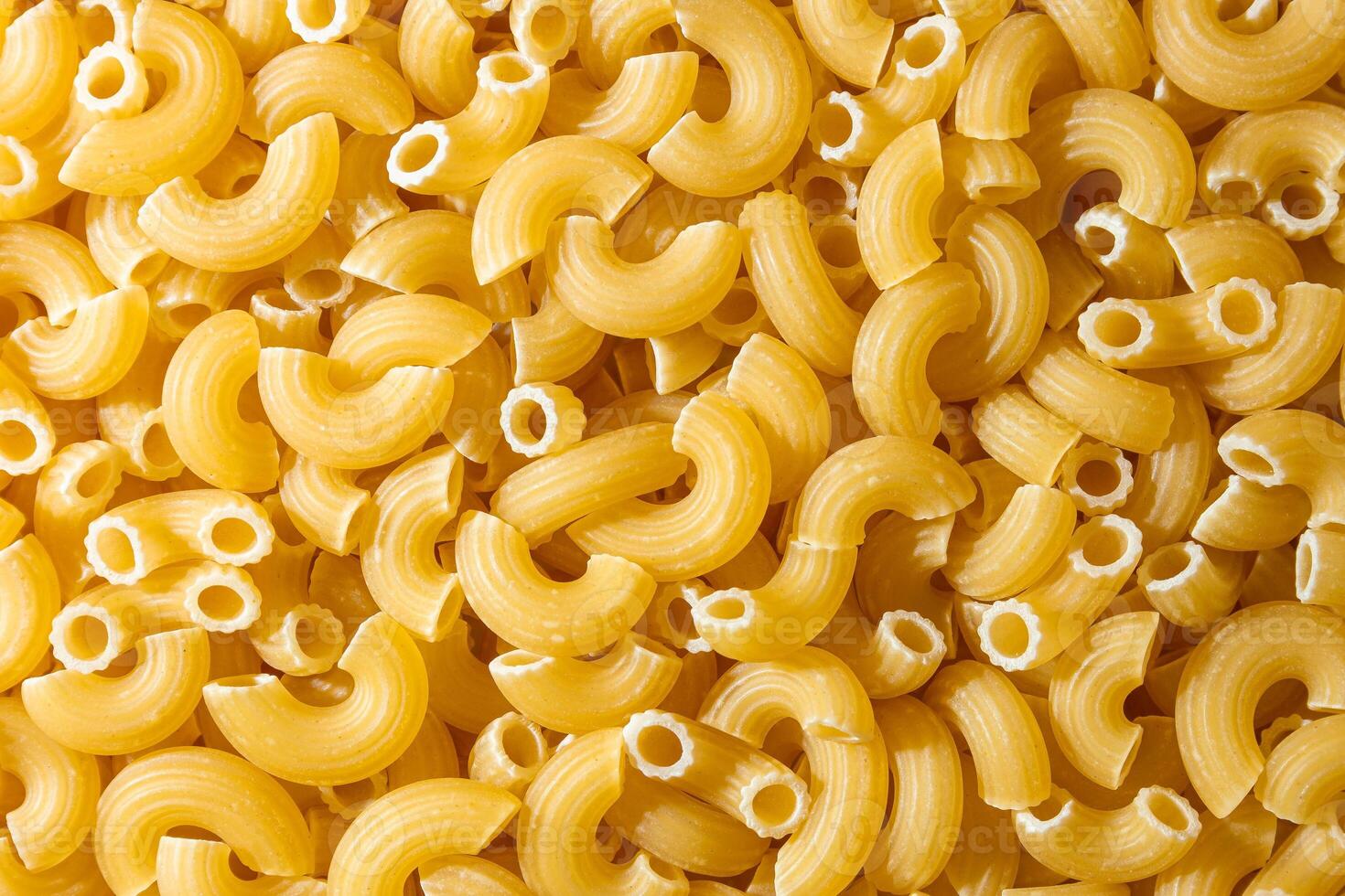 Uncooked Chifferi Rigati Pasta. A Culinary Canvas of Chifferi Rigati, Creating a Lively and Textured Background for Gourmet Cooking. Dry Pasta. Raw Macaroni - Top View, Flat Lay photo