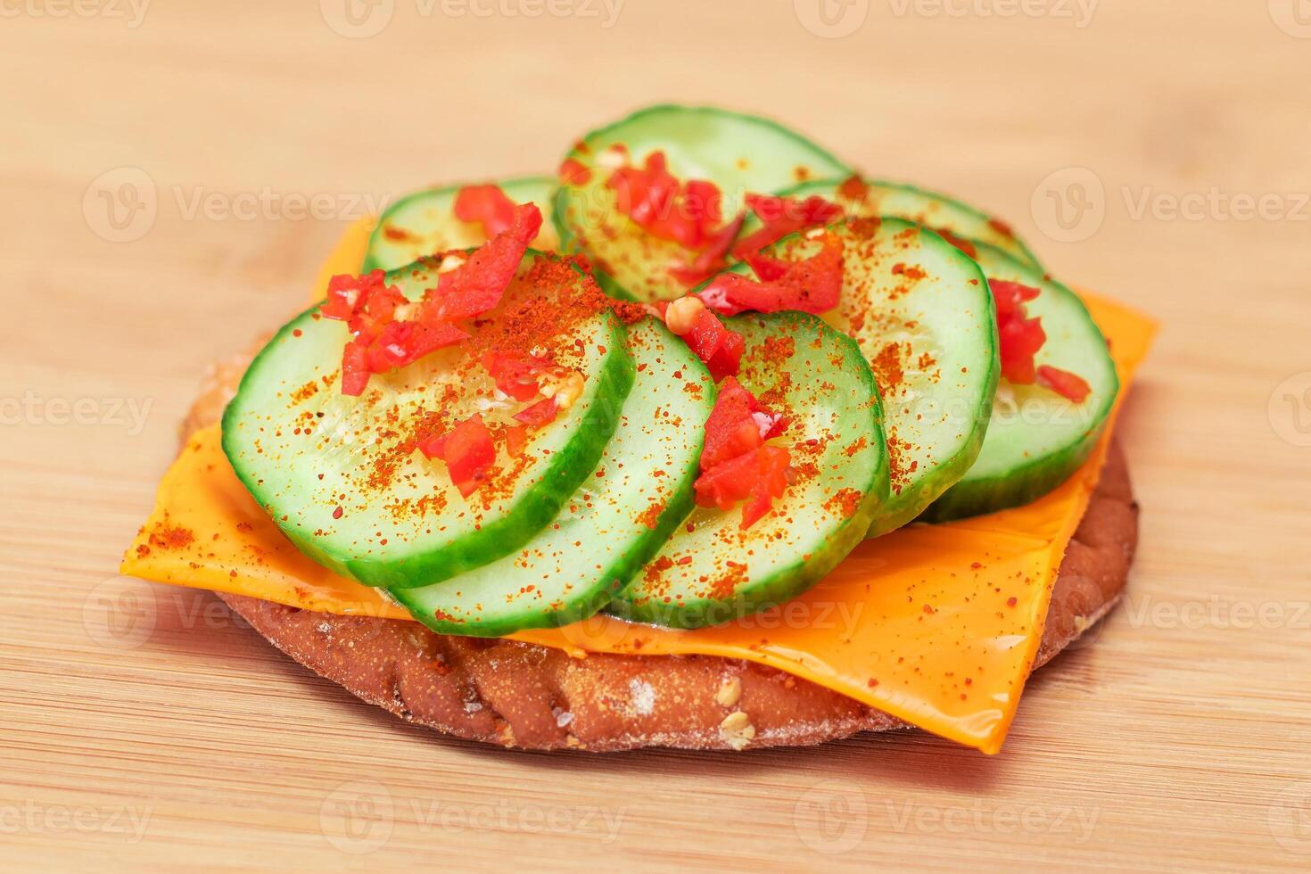 Crispy Cracker Sandwich with Fresh Cucumber, Cheese and Paprika on Cutting Board. Diet Food. Easy Breakfast. Quick and Healthy Sandwiches. Crispbread with Tasty Filling. Healthy Dietary Snack photo