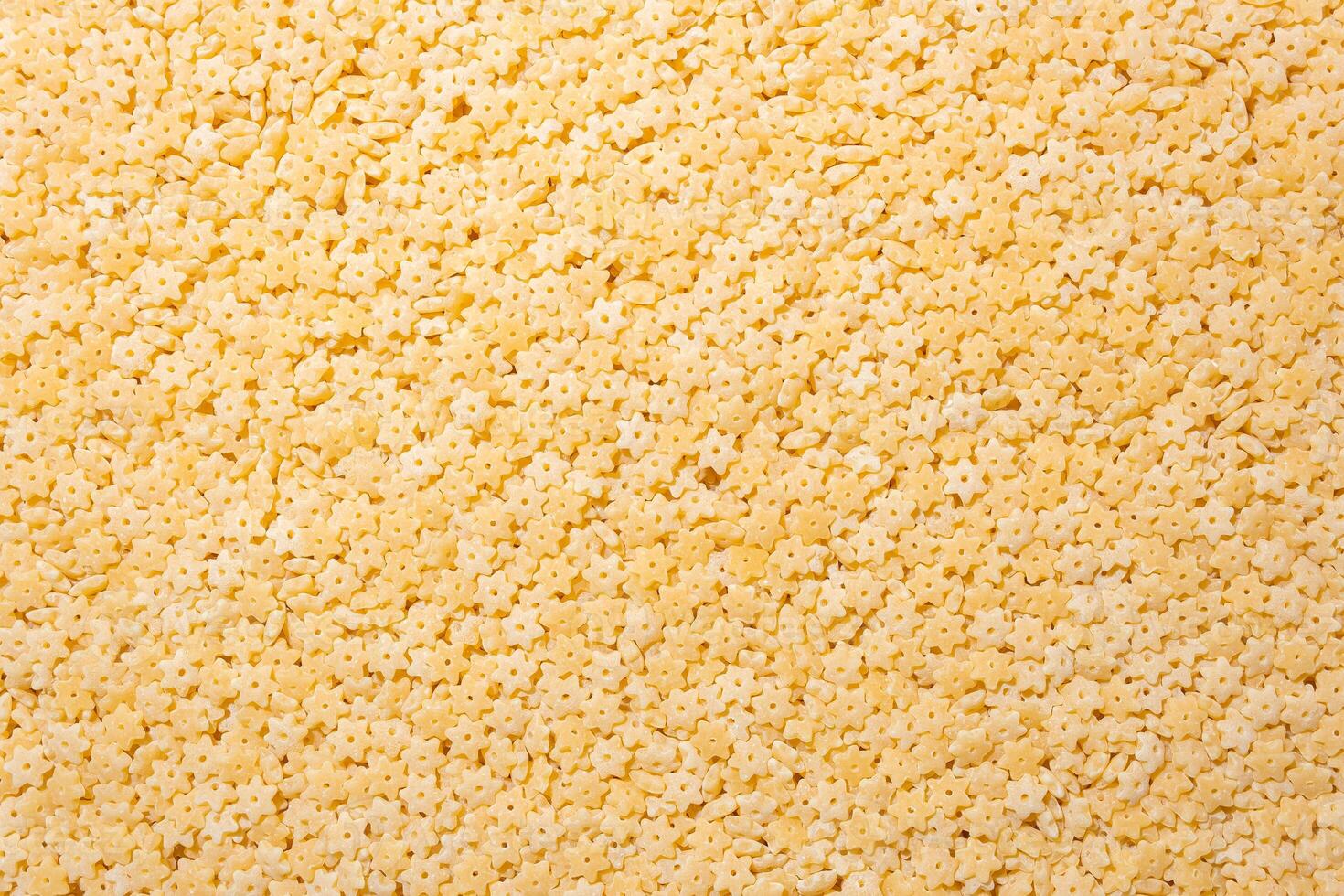 Uncooked Stelline Pasta. A Culinary Canvas of Stelline Macaroni, Creating a Lively and Textured Background for Gourmet Cooking. Dry Pasta. Raw Macaroni - Top View, Flat Lay photo