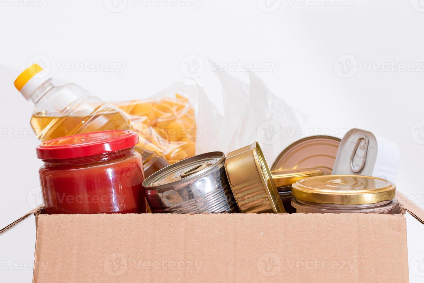 Donation Box of Free Food. Carton Box with Canned Food, Cereals and Grocery. Meal Reserves. Emergency Food Storage in Case of Crisis. Free Social Help, Blessings and Care. Strategic Food Supplies photo