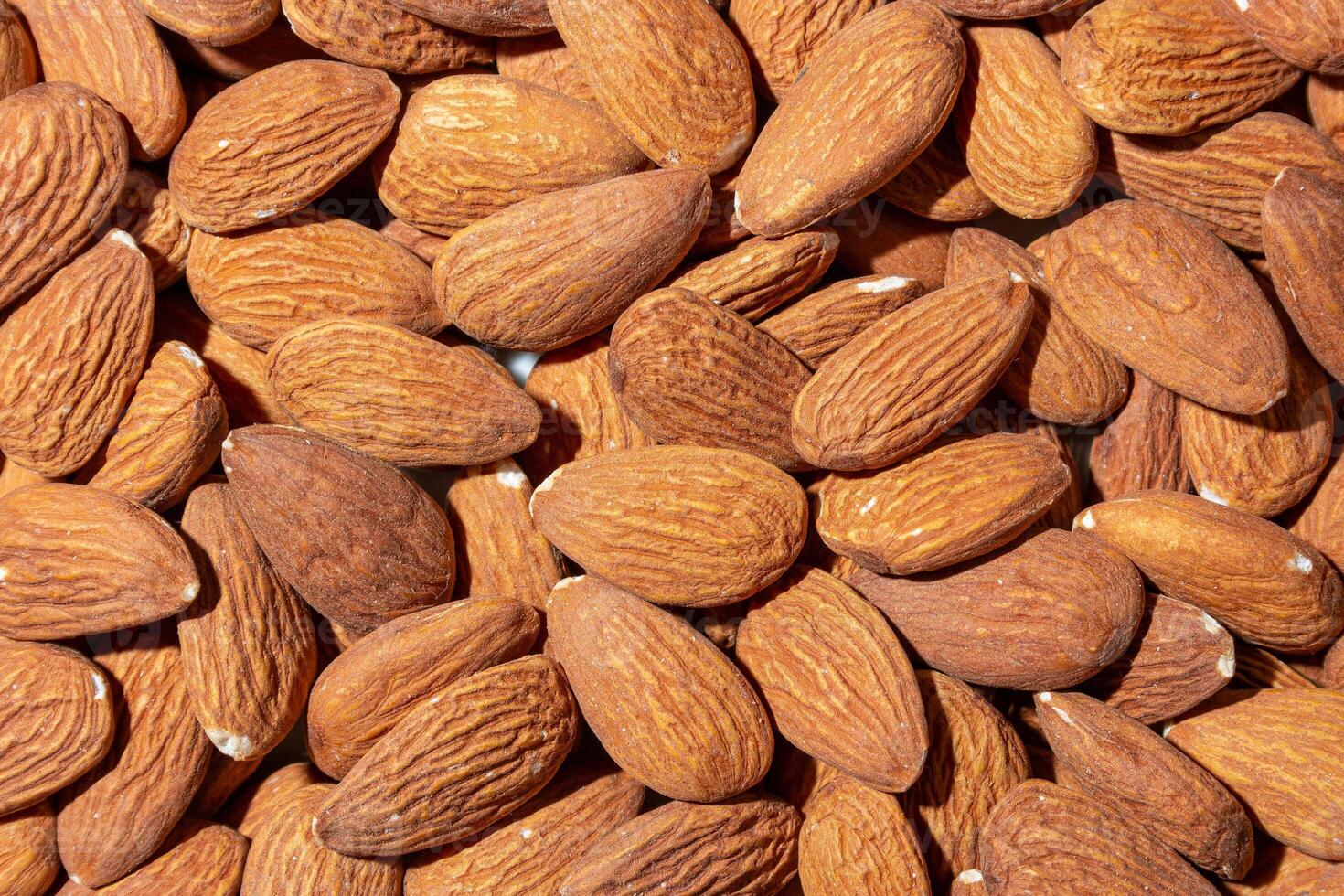 Scattered Almonds. Background from Almond Nuts. Natural High-Calorie Snacks photo