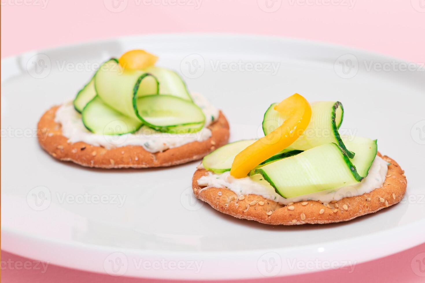 Crispy Cracker Sandwich with Fresh Cucumber, Yellow Paprika and Cottage Cheese on White Dish. Easy Breakfast. Quick and Healthy Sandwiches. Crispbread with Tasty Filling. Healthy Dietary Snack photo