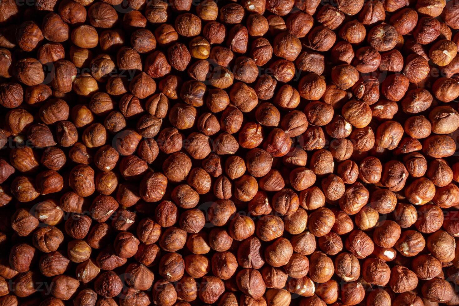 Scattered Peeled Hazelnut - Top View. Background from Hazelnuts. Natural High-Calorie Snacks photo