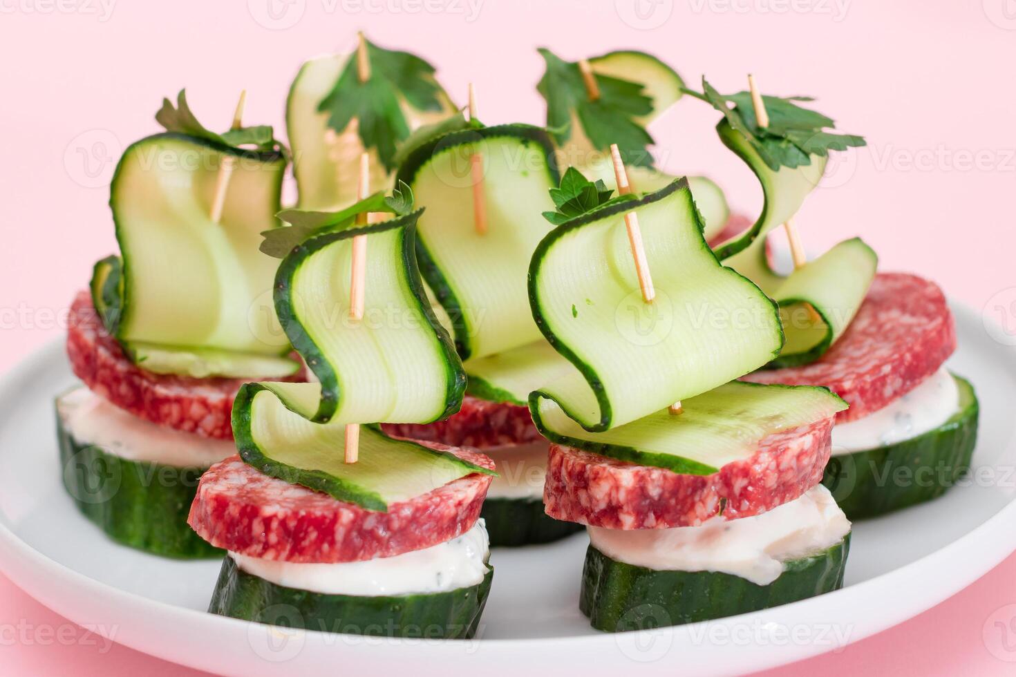 Canapes without Bread with Salami, Cucumber, Greens and Cream Cheese on White Plate. Easy Breakfast. Diet Food. Quick and Healthy Sandwiches. Healthy Snacks with Tasty Fillings photo