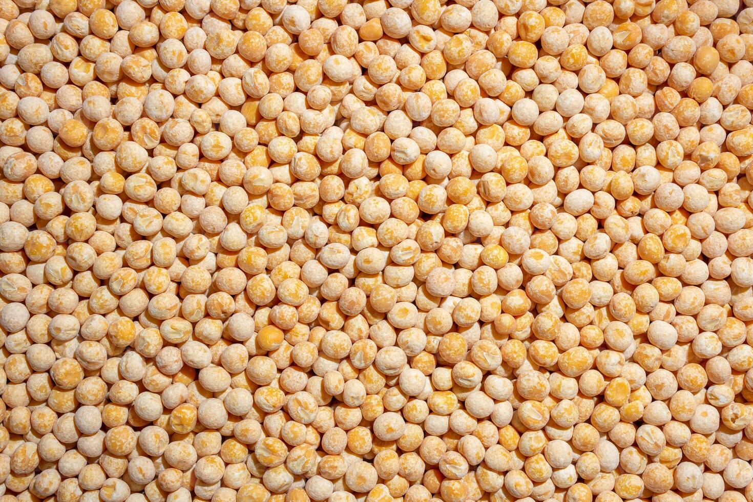 Uncooked Yellow Polished Peas Background. A Culinary Canvas of Dry Yellow Peas, Creating a Lively and Textured Background for Gourmet Cooking. Scattered Raw Polished Peas. Healthy Eating Ingredients photo