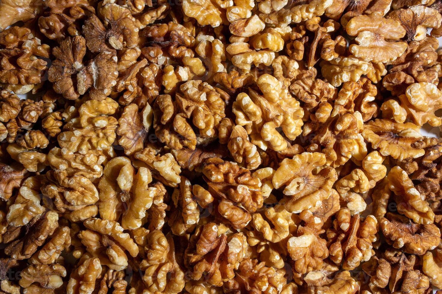 Scattered Shelled Walnuts. Background from Walnut. Natural High-Calorie Snacks photo