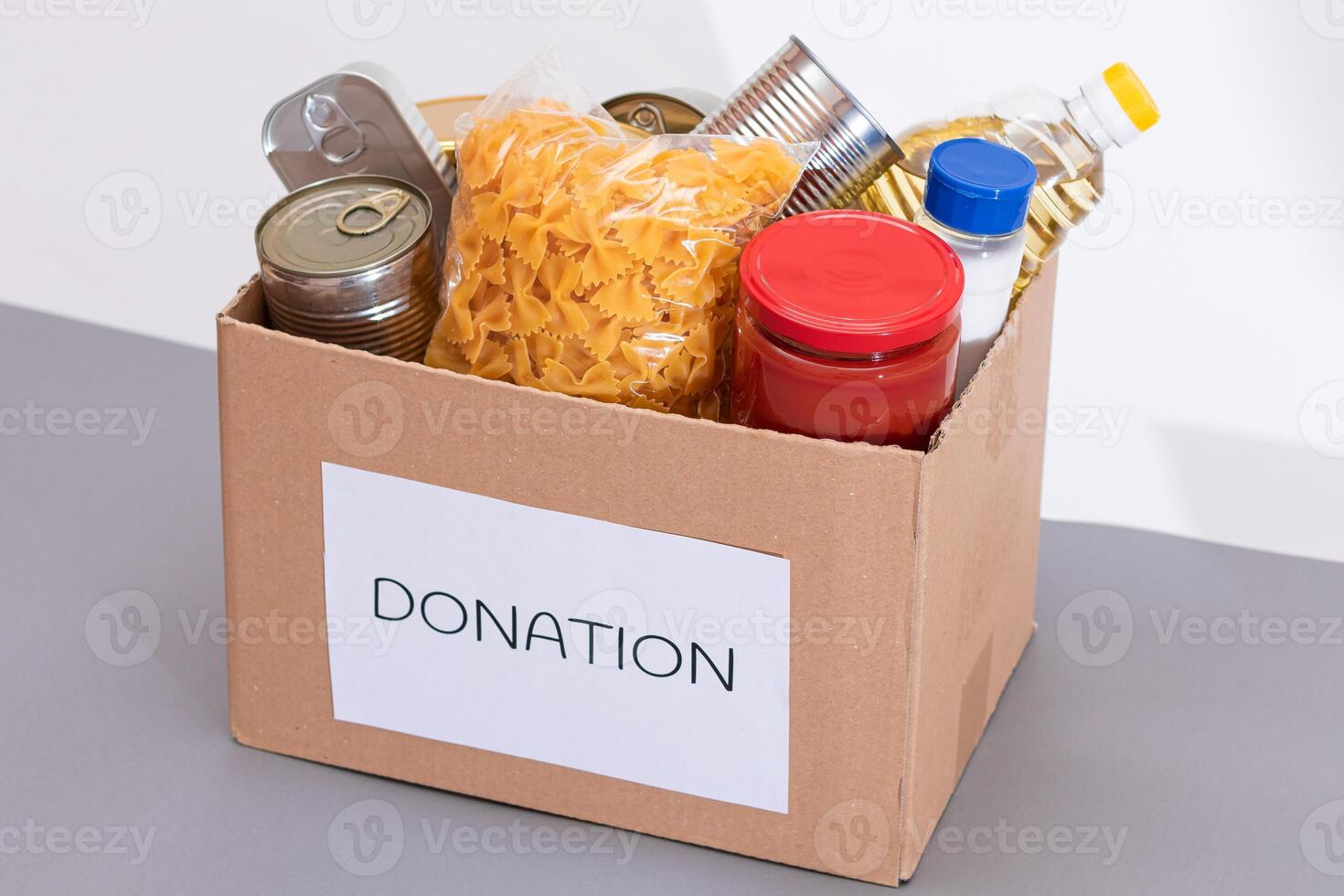 Donation Box of Free Food. Carton Box with Canned Food, Cereals and Grocery. Meal Reserves. Emergency Food Storage in Case of Crisis. Free Social Help, Blessings and Care. Strategic Food Supplies photo