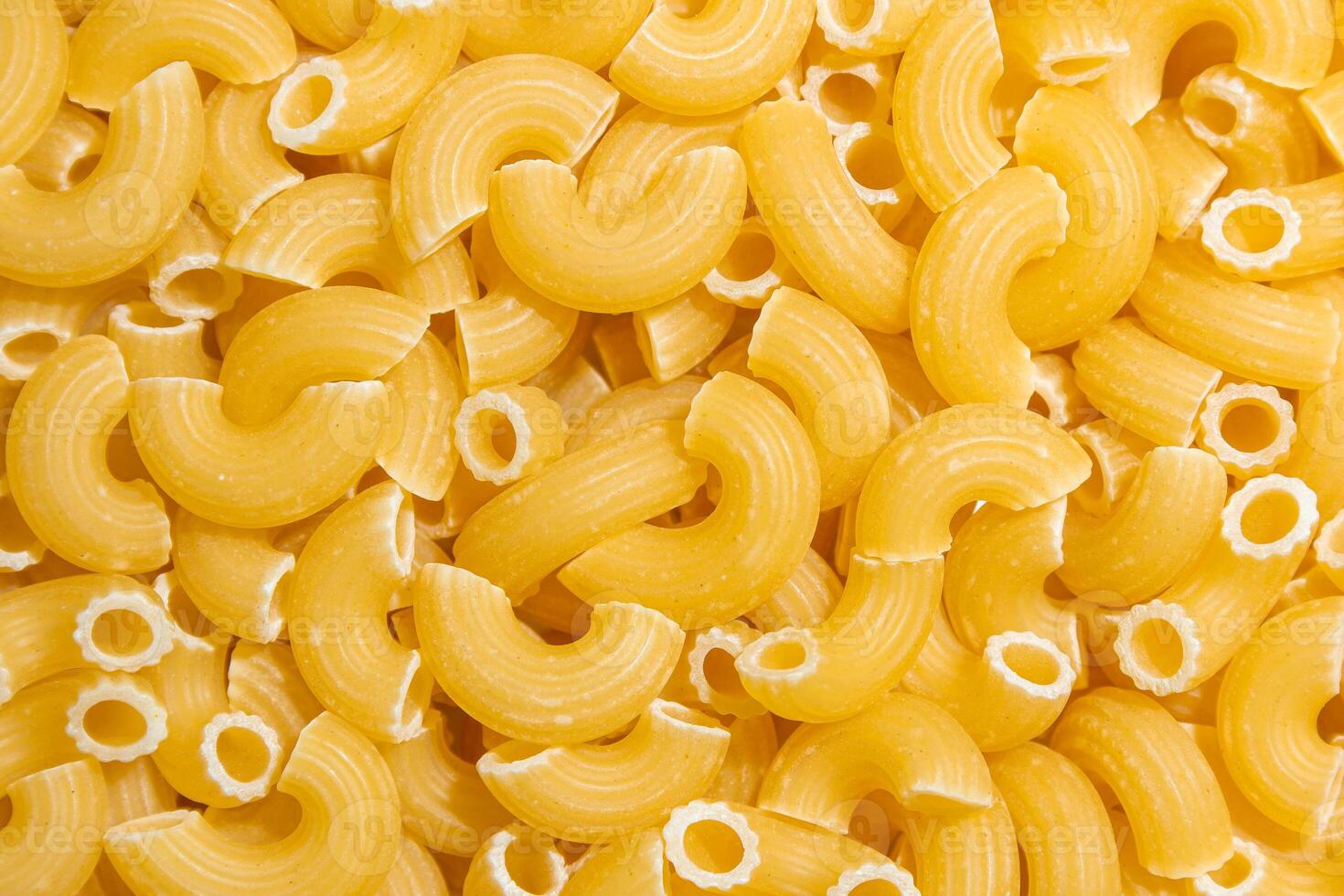 Uncooked Chifferi Rigati Pasta. A Culinary Canvas of Chifferi Rigati, Creating a Lively and Textured Background for Gourmet Cooking. Dry Pasta. Raw Macaroni - Top View, Flat Lay photo