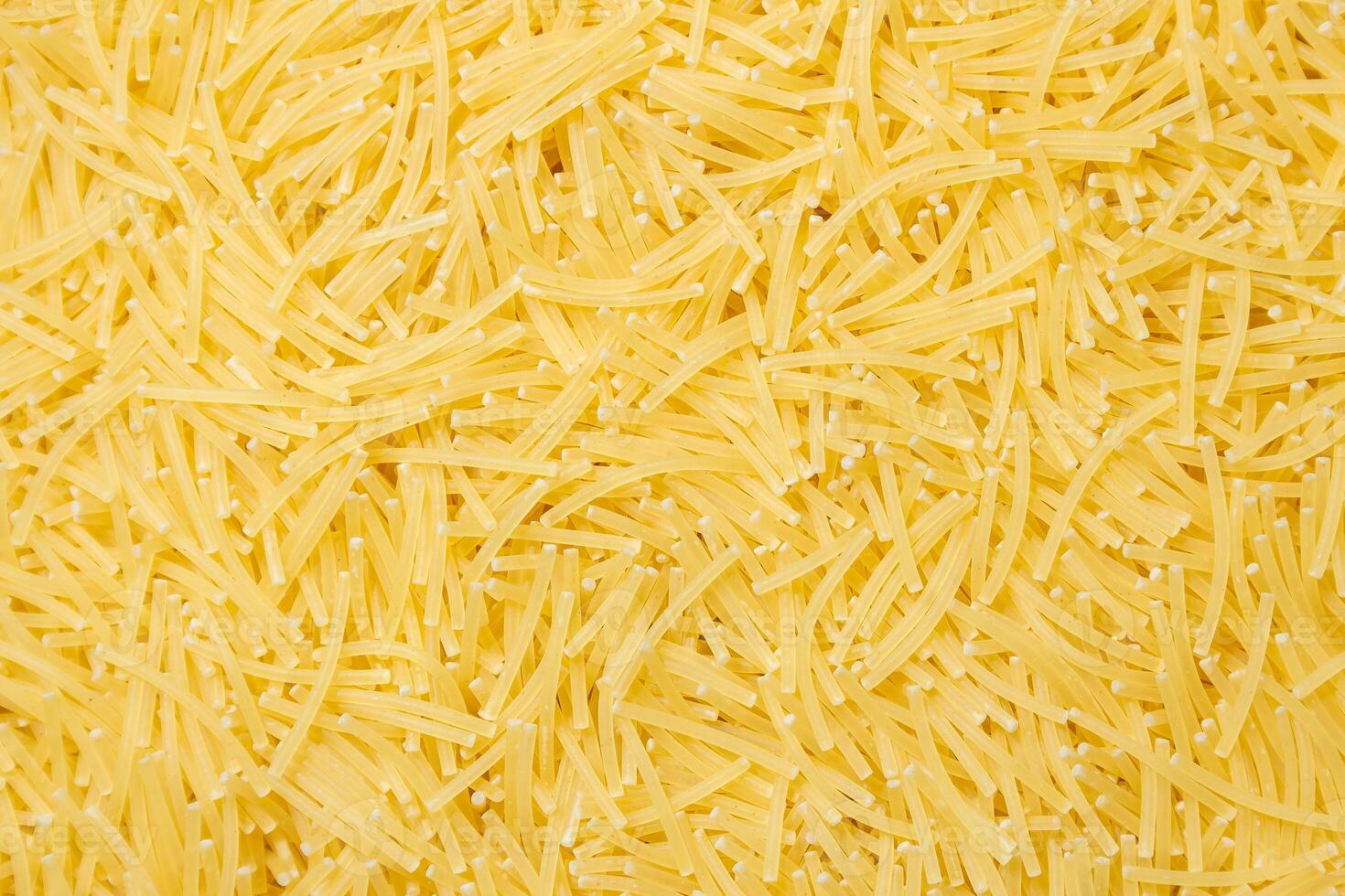 Uncooked Filini Pasta. A Culinary Canvas of Noodles, Creating a Lively and Textured Background for Gourmet Cooking. Dry Pasta. Raw Macaroni - Top View, Flat Lay photo