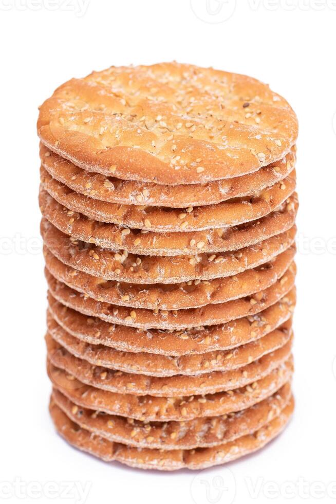 A Stack of Round Salt Crackers with Sesame Isolated on White Background. Dry Snacks - Isolation photo