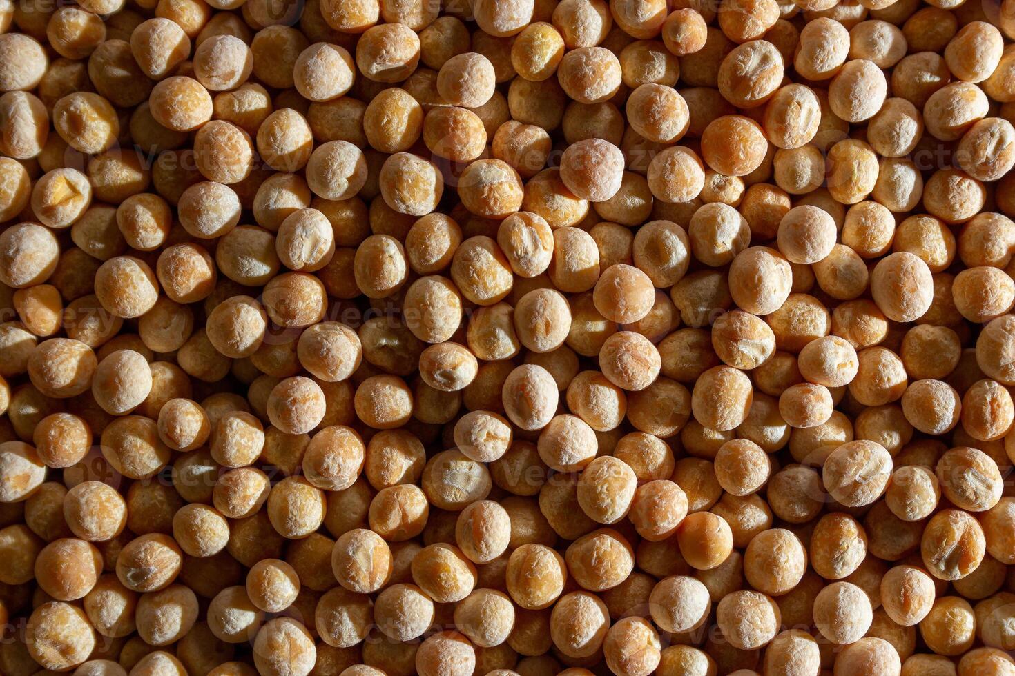 Uncooked Yellow Polished Peas Background. A Culinary Canvas of Dry Yellow Peas, Creating a Lively and Textured Background for Gourmet Cooking. Scattered Raw Polished Peas. Healthy Eating Ingredients photo