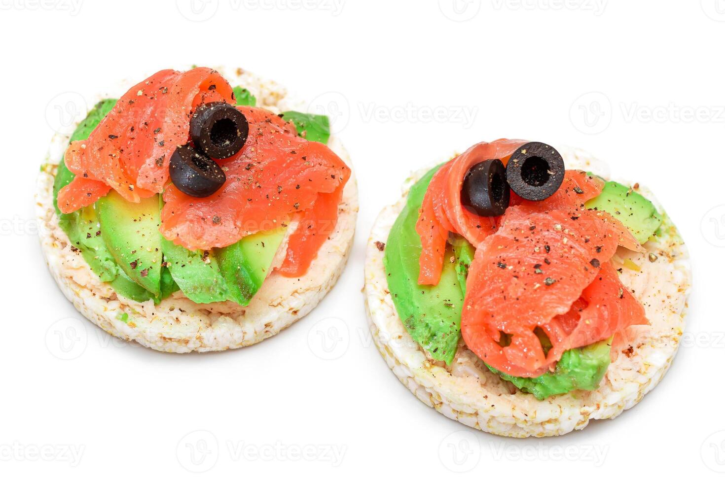 Rice Cake Sandwiches with Fresh Salmon, Avocado and Olives - Isolated on White. Easy Breakfast. Diet Food. Quick and Healthy Sandwiches. Crispbread with Tasty Filling. Healthy Dietary Snack - Isolation photo