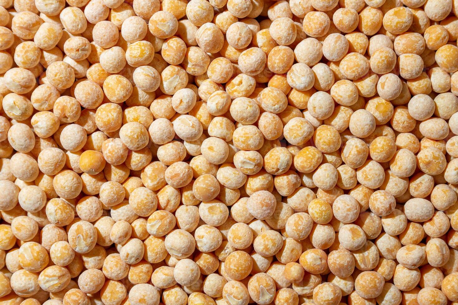 Uncooked Yellow Polished Peas Background. A Culinary Canvas of Dry Yellow Peas, Creating a Lively and Textured Background for Gourmet Cooking. Scattered Raw Polished Peas. Healthy Eating Ingredients photo