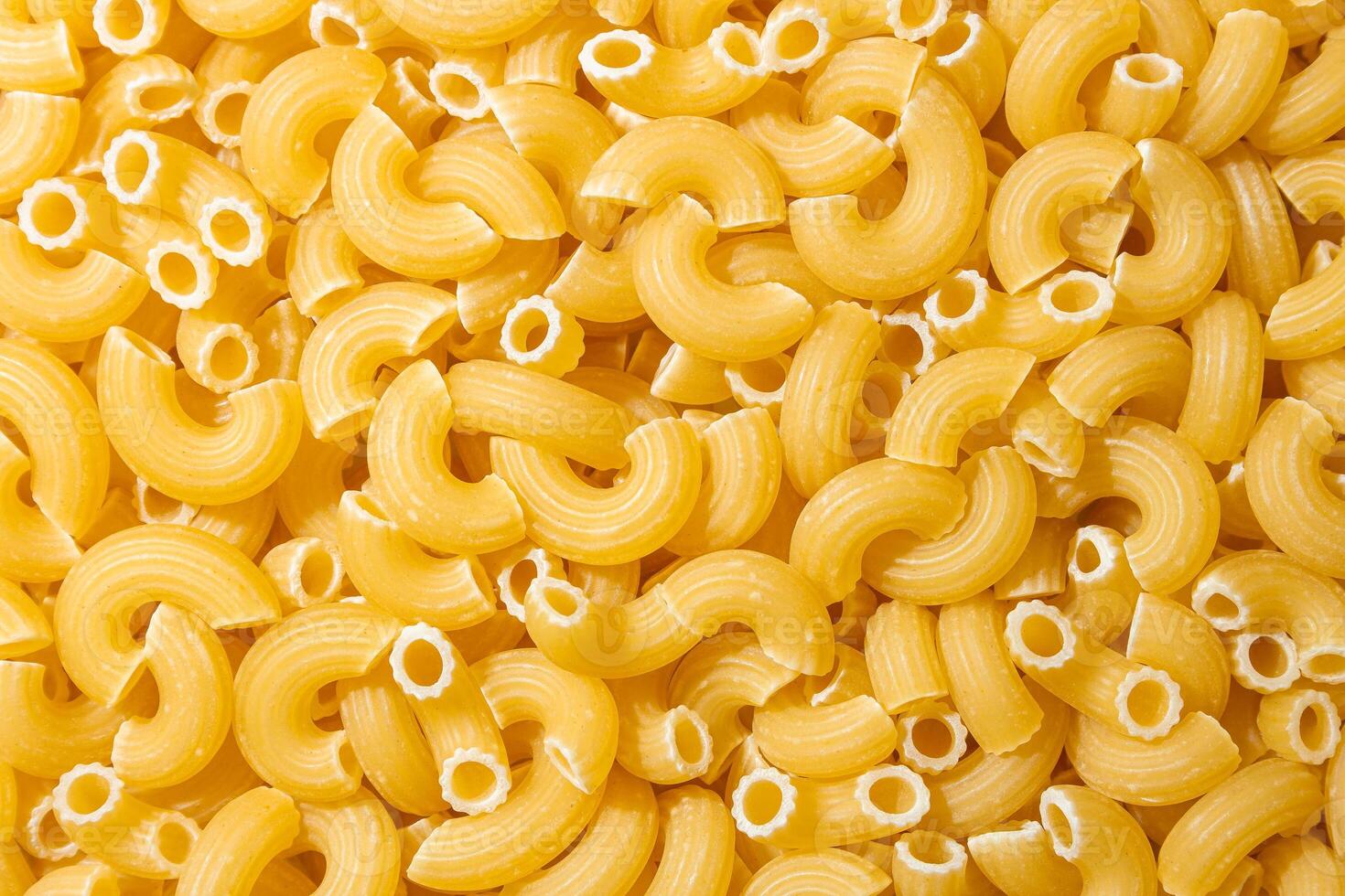 Uncooked Chifferi Rigati Pasta. A Culinary Canvas of Chifferi Rigati, Creating a Lively and Textured Background for Gourmet Cooking. Dry Pasta. Raw Macaroni - Top View, Flat Lay photo