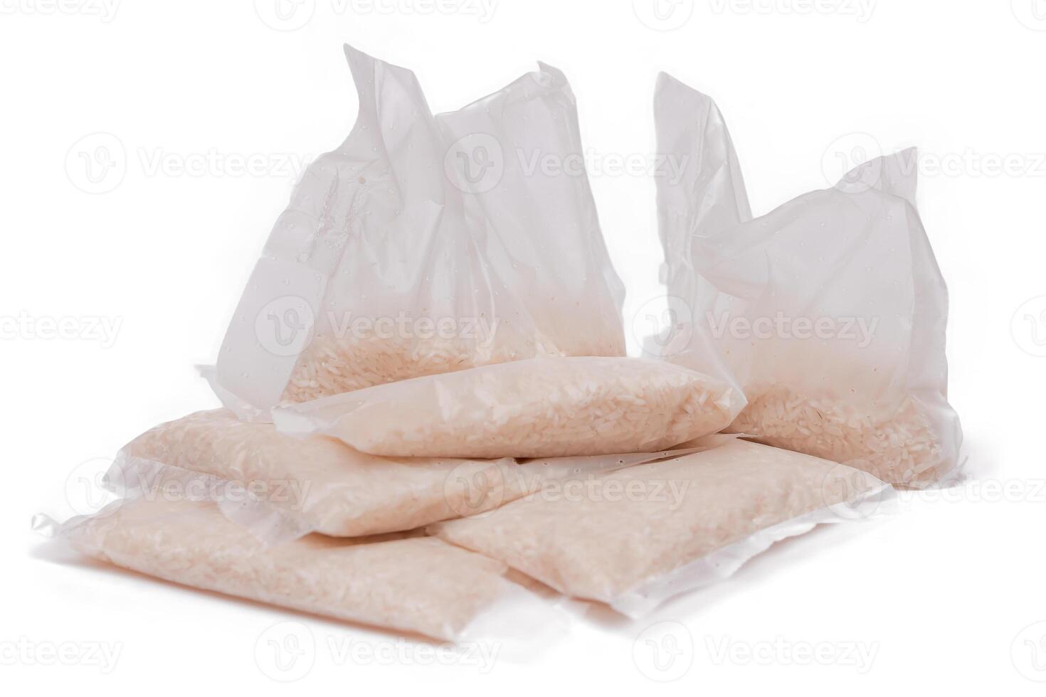 A Plastic Bags of White Long Grain Rice - Isolated on White Background. Small Transparent Packages with Dry Rice - Isolation photo