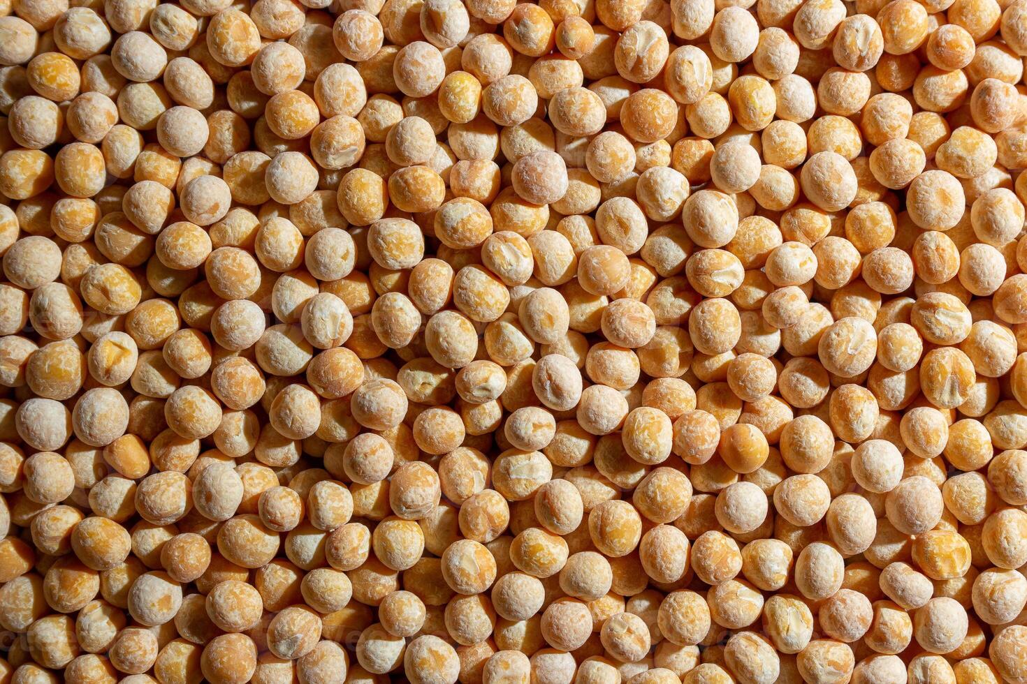 Uncooked Yellow Polished Peas Background. A Culinary Canvas of Dry Yellow Peas, Creating a Lively and Textured Background for Gourmet Cooking. Scattered Raw Polished Peas. Healthy Eating Ingredients photo