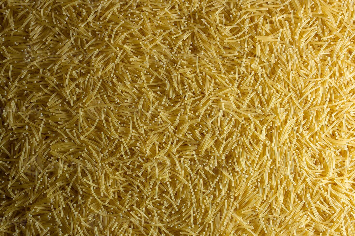 Uncooked Filini Pasta. A Culinary Canvas of Noodles, Creating a Lively and Textured Background for Gourmet Cooking. Dry Pasta. Raw Macaroni - Top View, Flat Lay photo