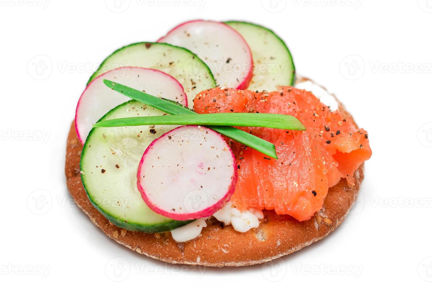 Crispy Cracker Sandwich with Salmon, Cucumber, Radish, Cottage Cheese and Green Onions - Isolated on White. Easy Breakfast. Quick and Healthy Sandwiches. Crispbread with Tasty Filling - Isolation photo