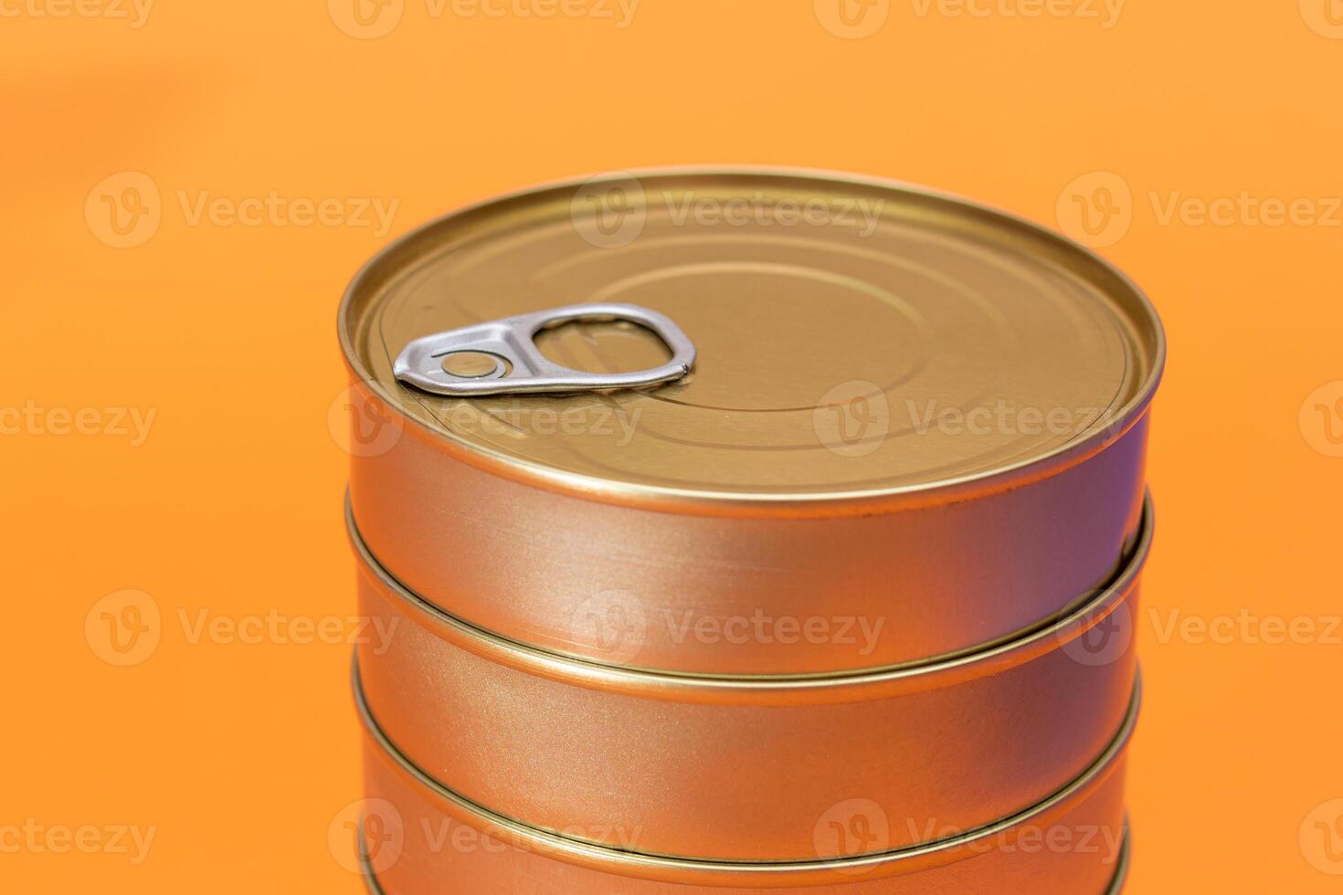 A Group of Stacked Tin Cans with Blank Edges on Orange Background. Canned Food. Different Aluminum Cans for Safe and Long Term Storage of Food. Steel Sealed Food Storage Containers photo